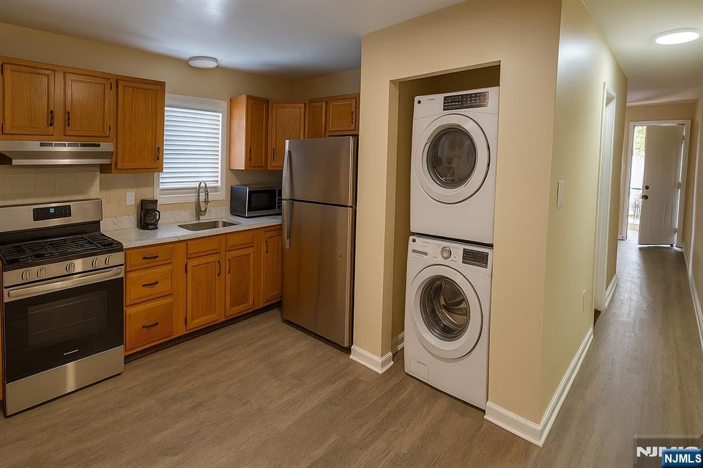 a kitchen with a washer and dryer in it