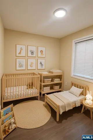 a bedroom with two beds and a window