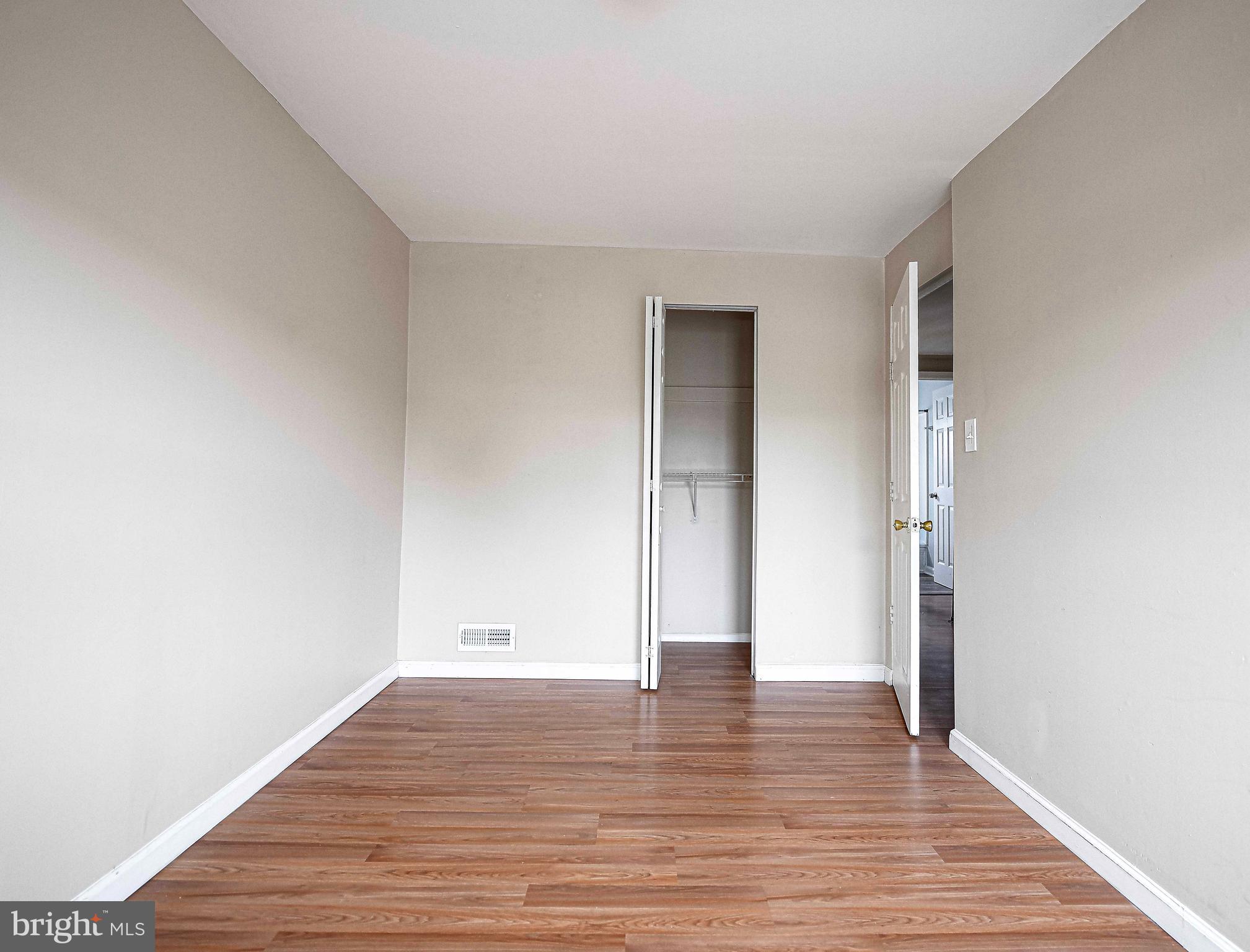 2033 Kelmore Road Dundalk, MD 21222 - Photo 19 of 31 a view of an empty room with wooden floor and closet