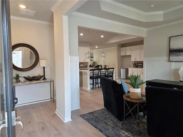 a living room with furniture a dining table with kitchen view