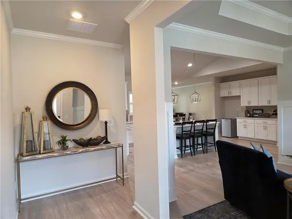 a living room with granite countertop furniture a sink a dining table and kitchen view