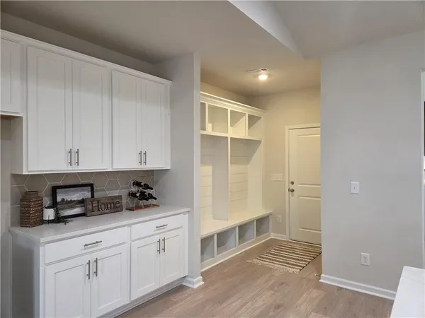 a kitchen with granite countertop white cabinets and stainless steel appliances