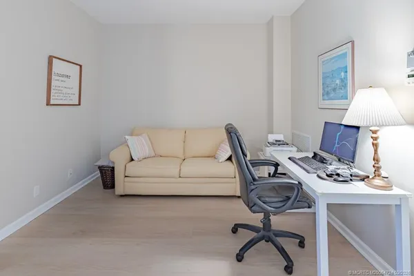 a view of a livingroom with furniture and a window