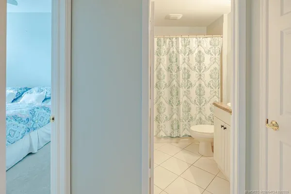 a bathroom with a granite countertop sink a mirror and a bathtub