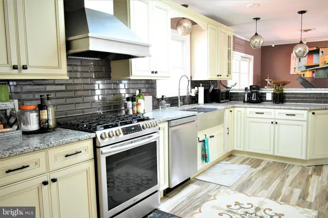 a kitchen with kitchen island granite countertop a sink stainless steel appliances and cabinets