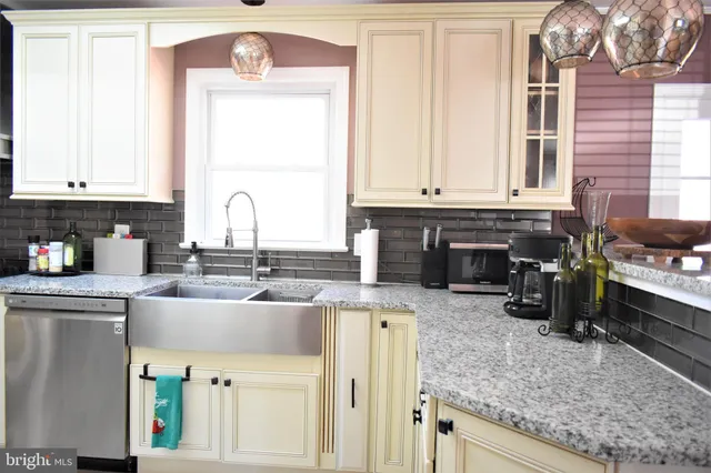 a kitchen with white cabinets and refrigerator