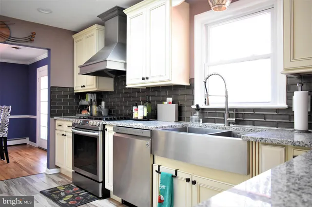 a living room with furniture a fireplace and a large window