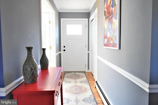 a view of entryway with furniture and wooden floor