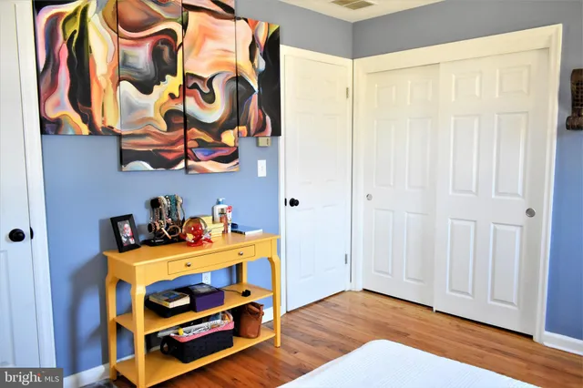 a view of a house with a yard and wooden fence