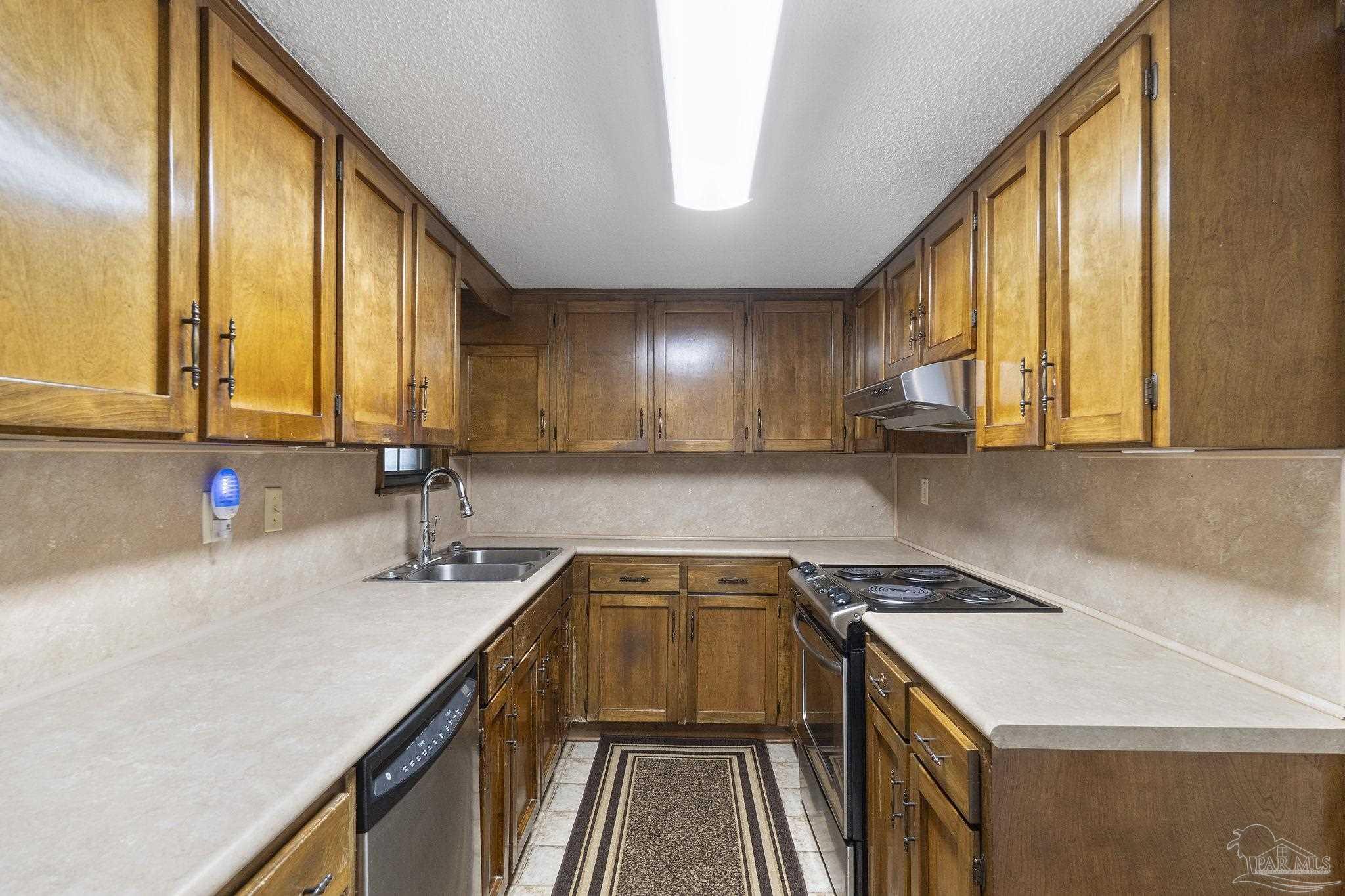 4285 7th Avenue Pace, FL 32571 - Photo 14 of 59 a view of a kitchen with a sink and cabinets