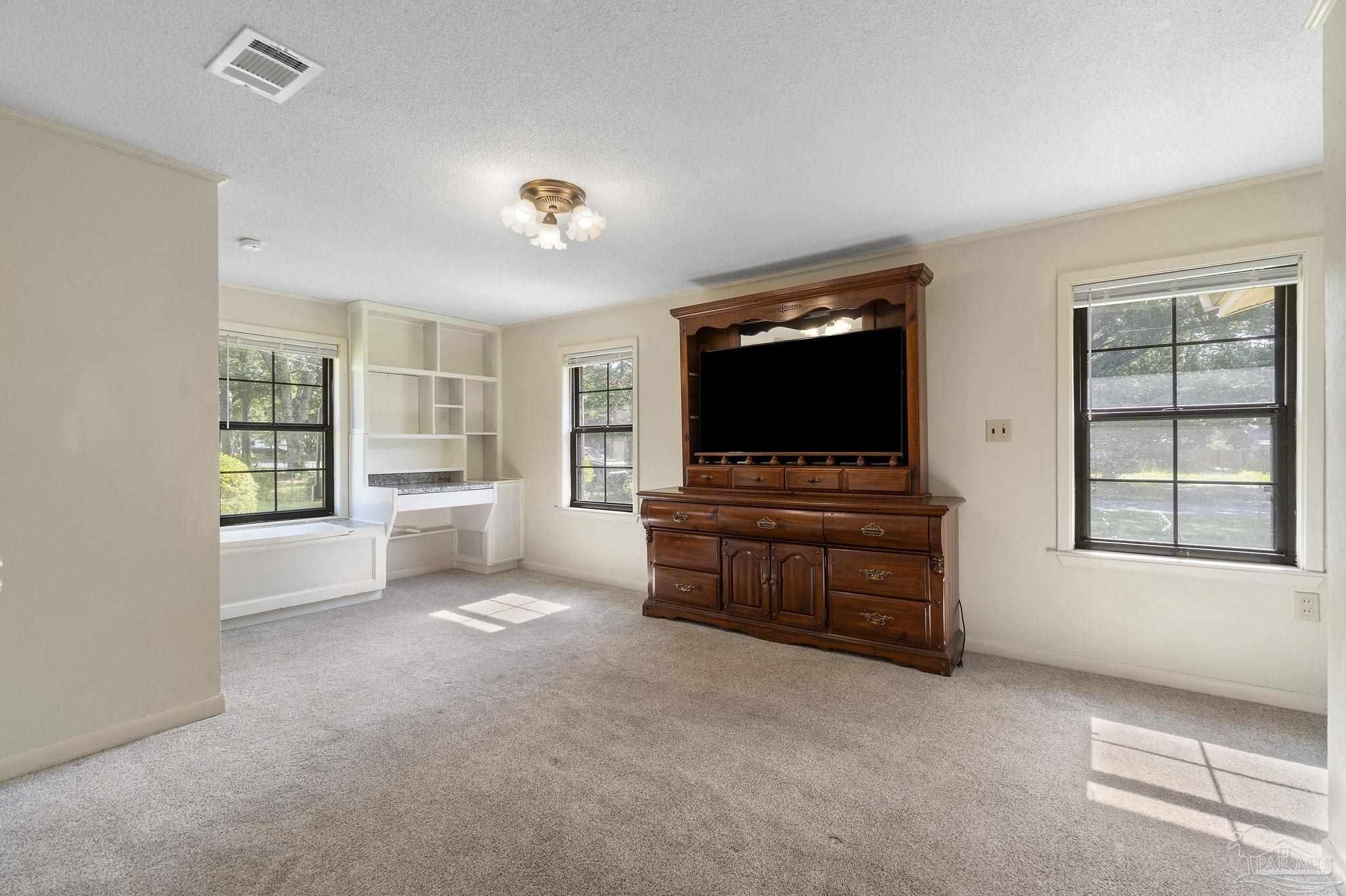 4285 7th Avenue Pace, FL 32571 - Photo 17 of 59 a room with furniture and flat screen tv