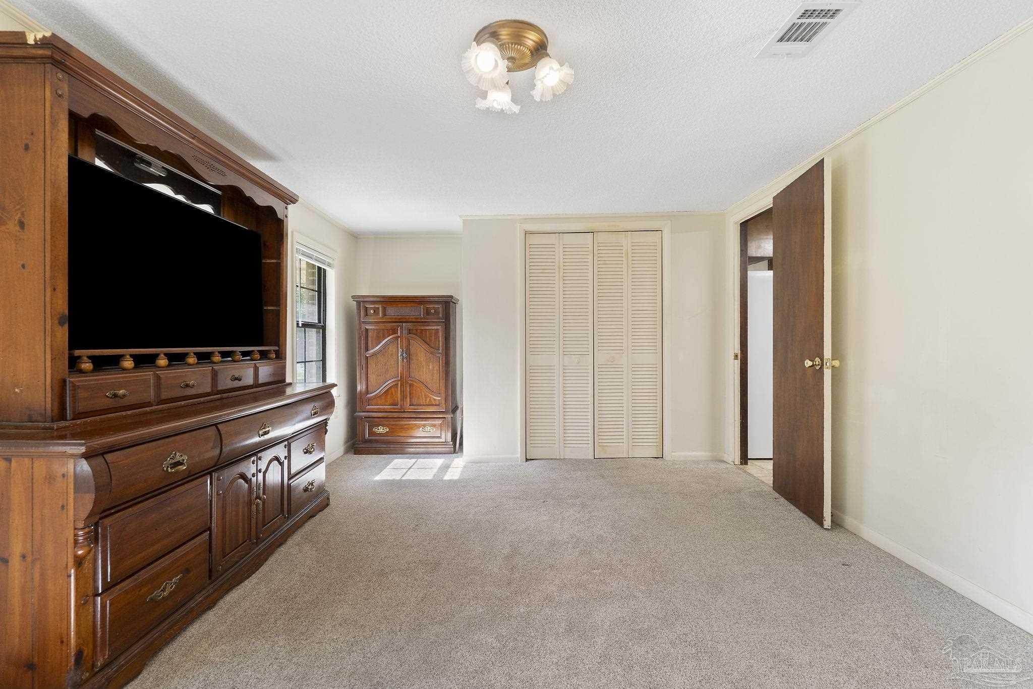 4285 7th Avenue Pace, FL 32571 - Photo 20 of 59 a living room with furniture and a flat screen tv