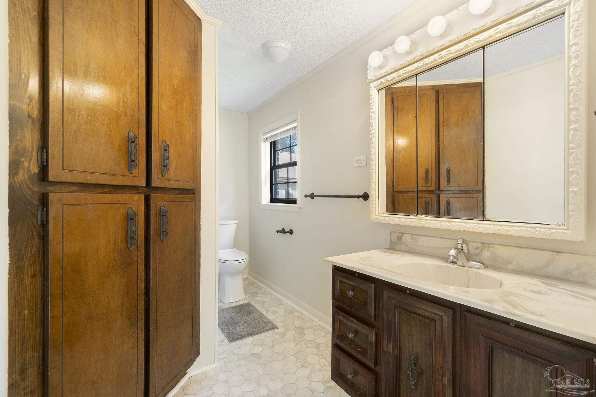 4285 7th Avenue Pace, FL 32571 - Photo 22 of 59 a bathroom with a sink a toilet and a mirror