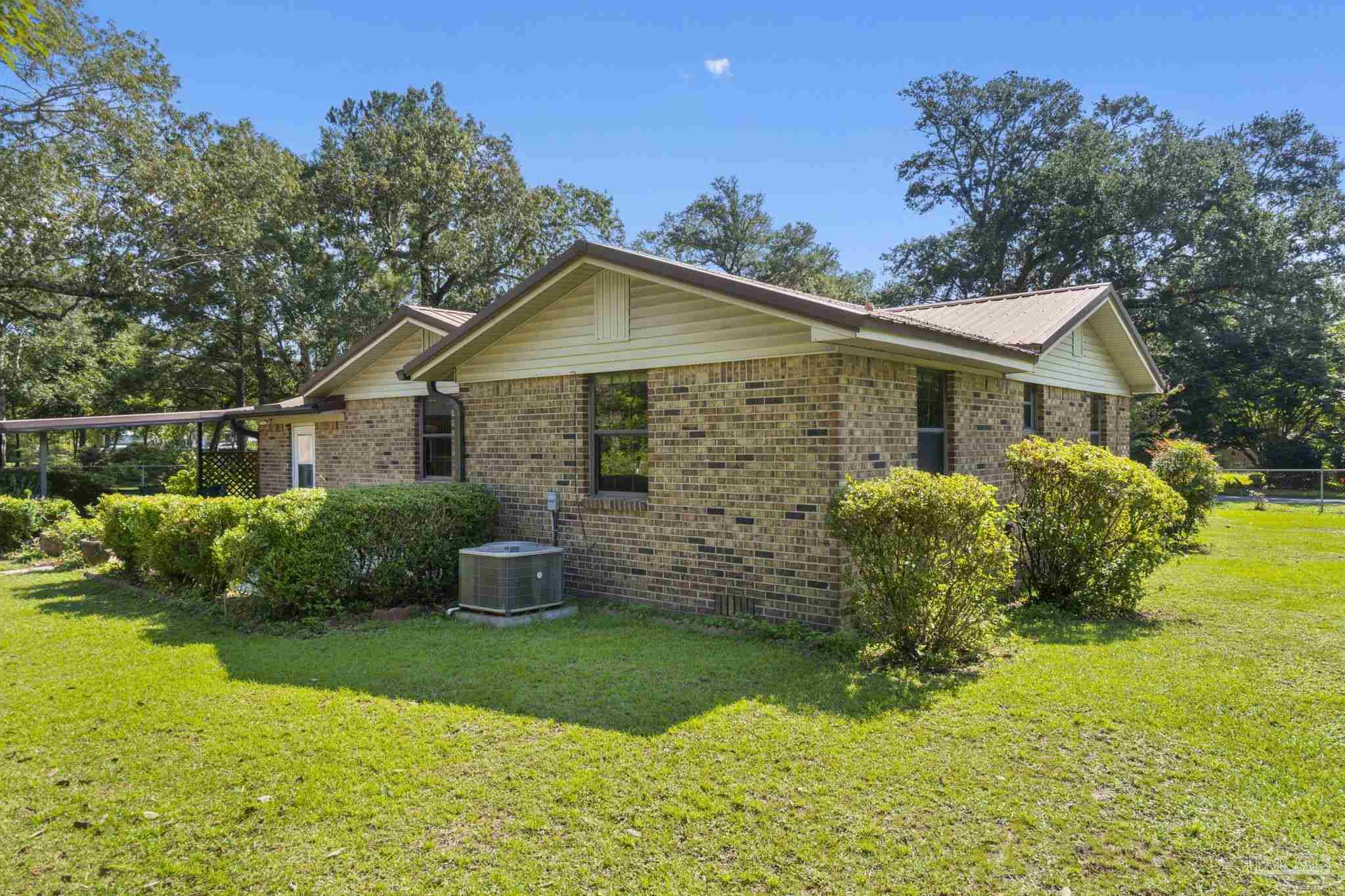 4285 7th Avenue Pace, FL 32571 - Photo 37 of 59 a front view of a house with garden
