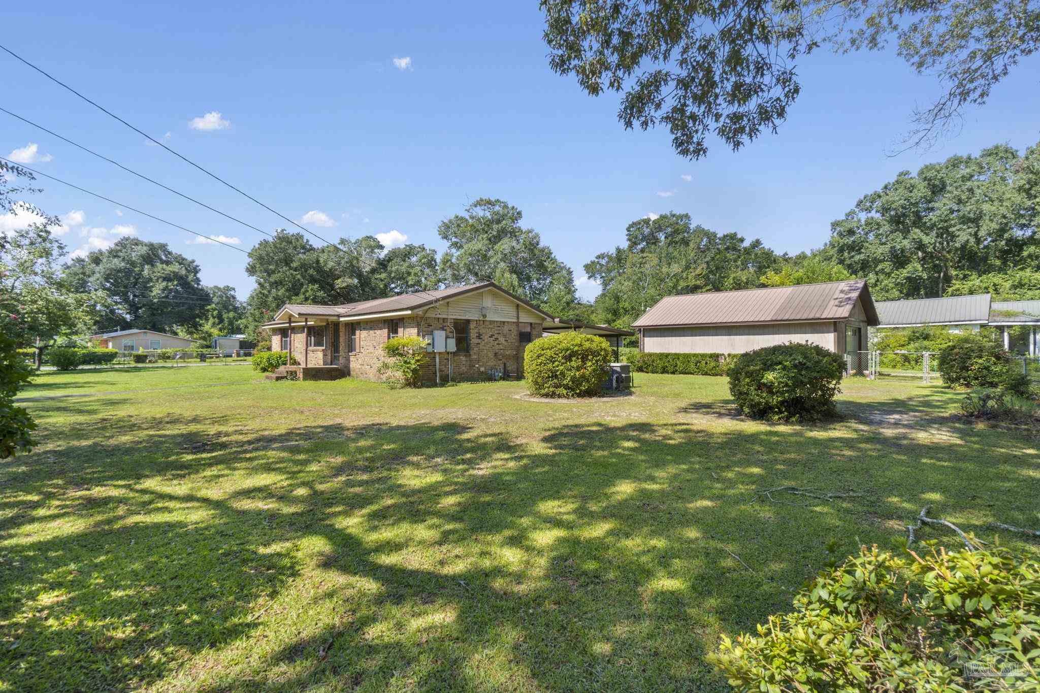 4285 7th Avenue Pace, FL 32571 - Photo 42 of 59 a front view of a house with garden