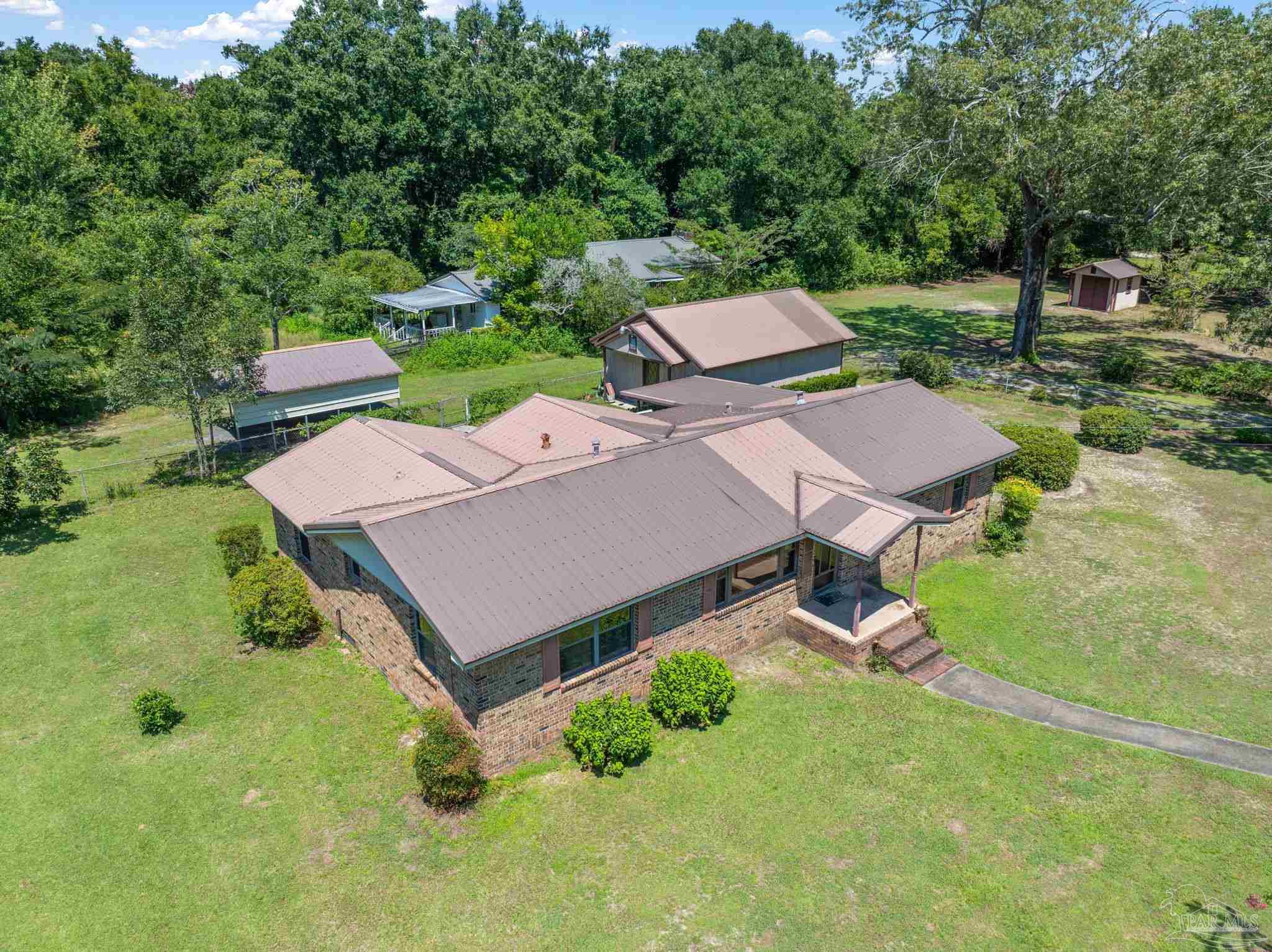 4285 7th Avenue Pace, FL 32571 - Photo 43 of 59 an aerial view of a house with swimming pool and outdoor space
