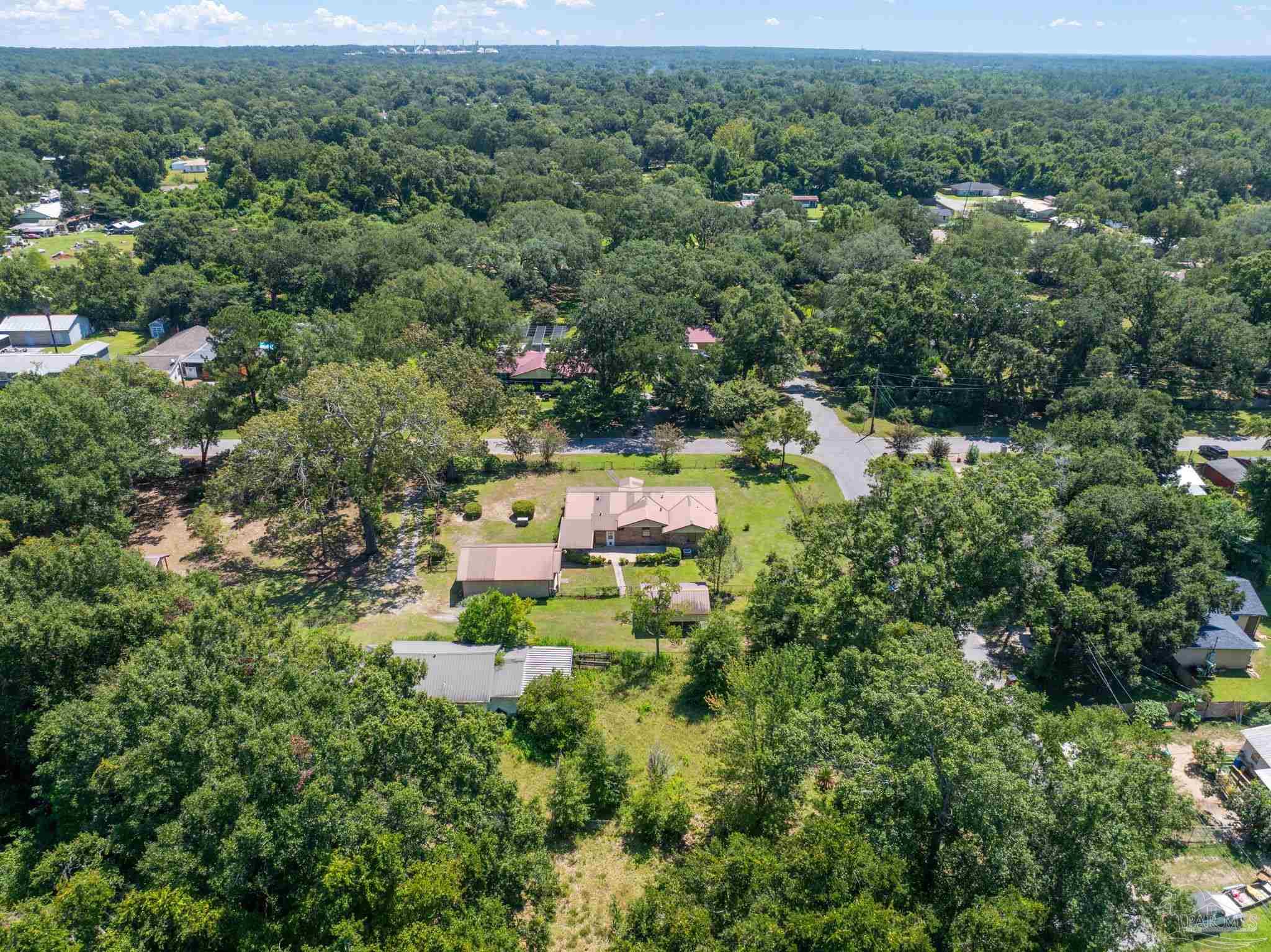 4285 7th Avenue Pace, FL 32571 - Photo 53 of 59 an aerial view of residential house with outdoor space and trees all around
