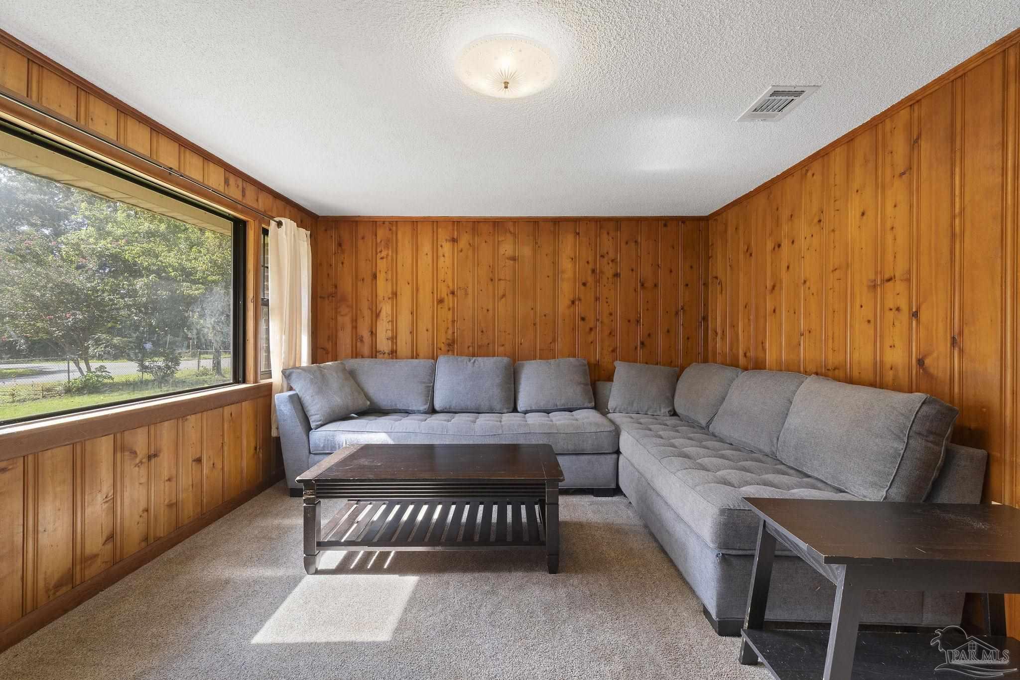 4285 7th Avenue Pace, FL 32571 - Photo 7 of 59 a living room with furniture and a large window