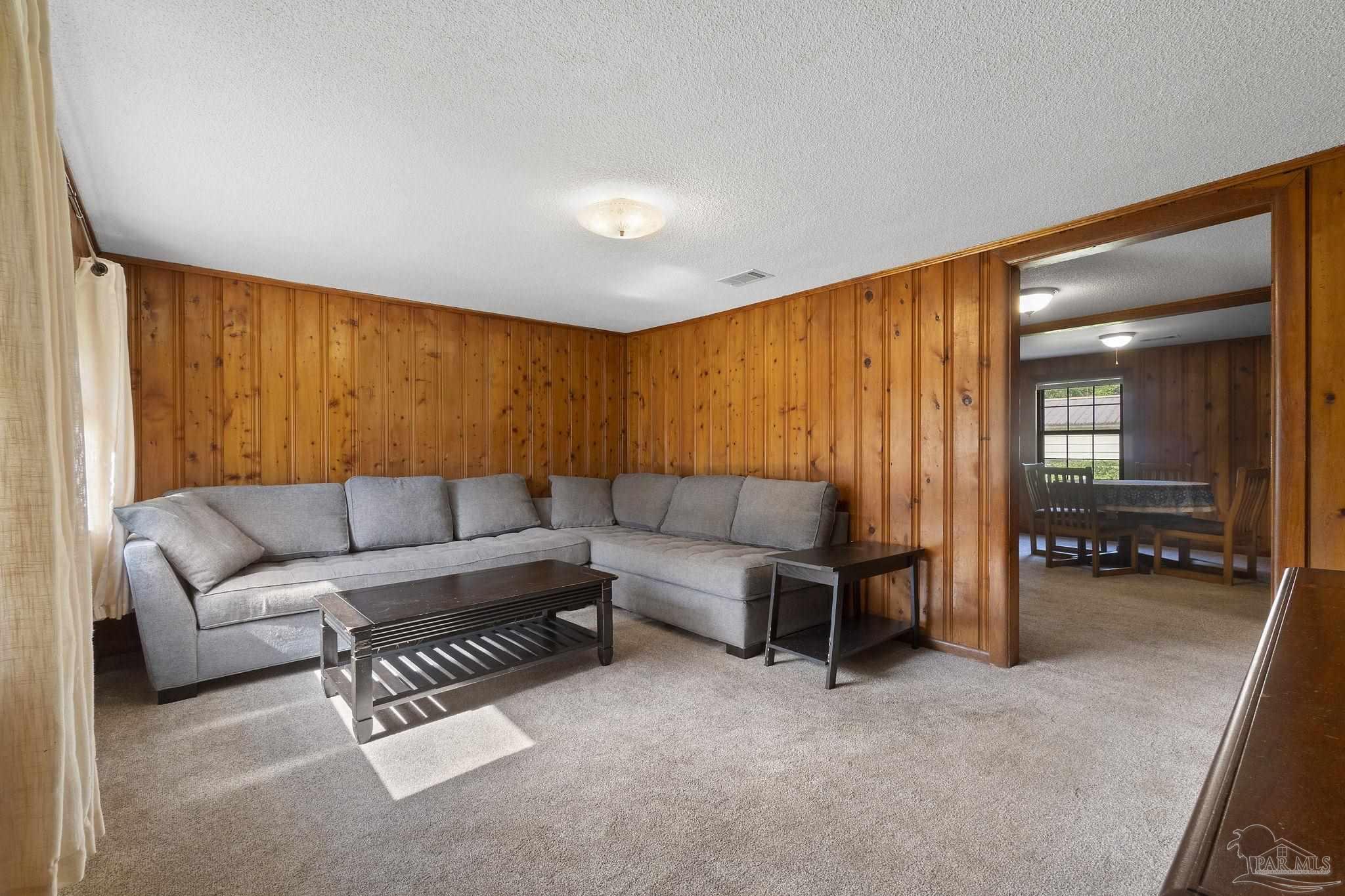 4285 7th Avenue Pace, FL 32571 - Photo 8 of 59 a living room with furniture and a large window