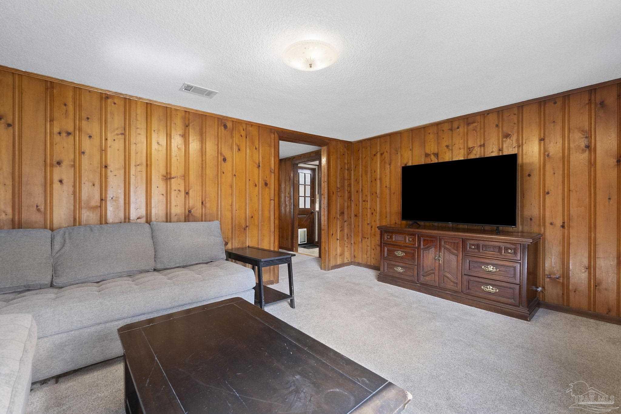 4285 7th Avenue Pace, FL 32571 - Photo 9 of 59 a living room with furniture and a flat screen tv