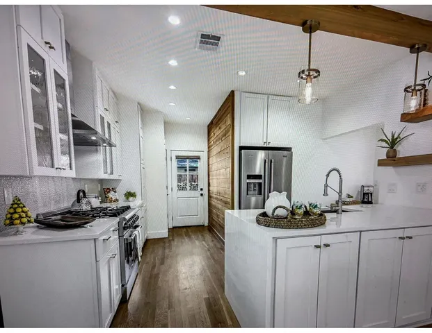 a kitchen with sink a refrigerator and cabinets