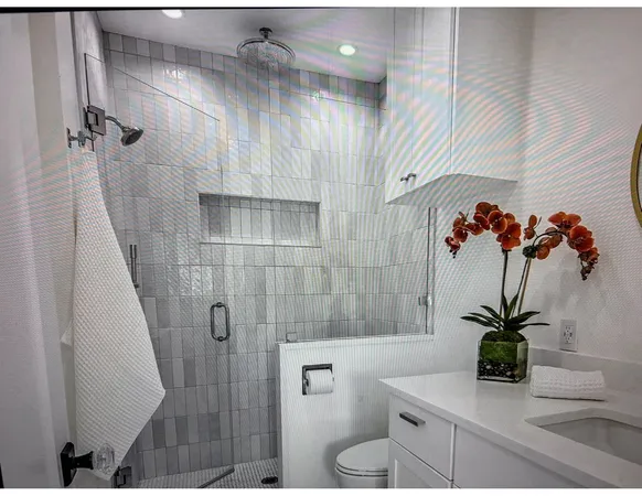 a bathroom with a shower a toilet and a sink