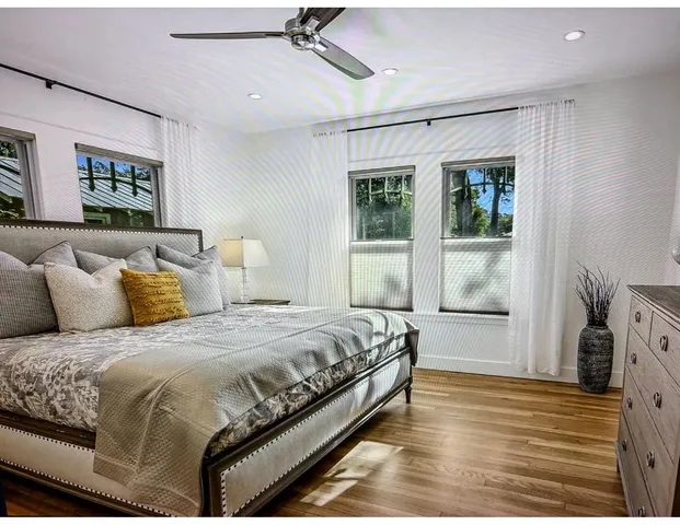 a spacious bedroom with a bed and a window