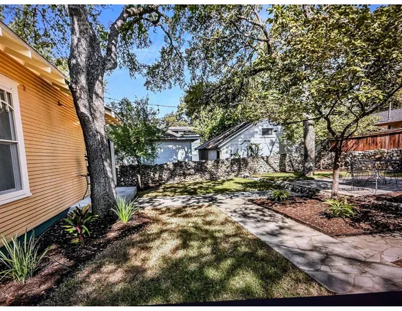 a view of a backyard with large trees