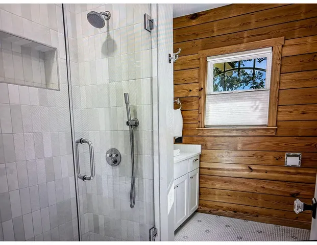 a bathroom with a shower and a sink