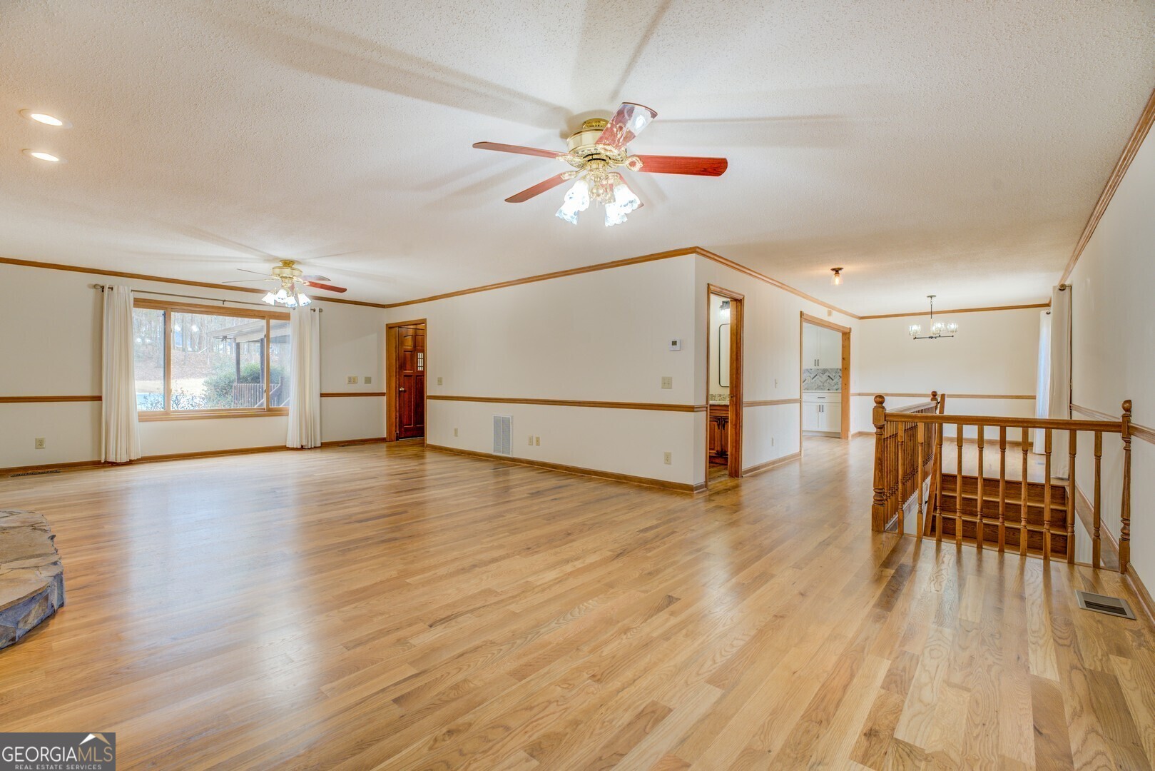 71 Canvasback Court Monticello, GA 31064 - Photo 22 of 78 a view of an empty room with wooden floor and a window