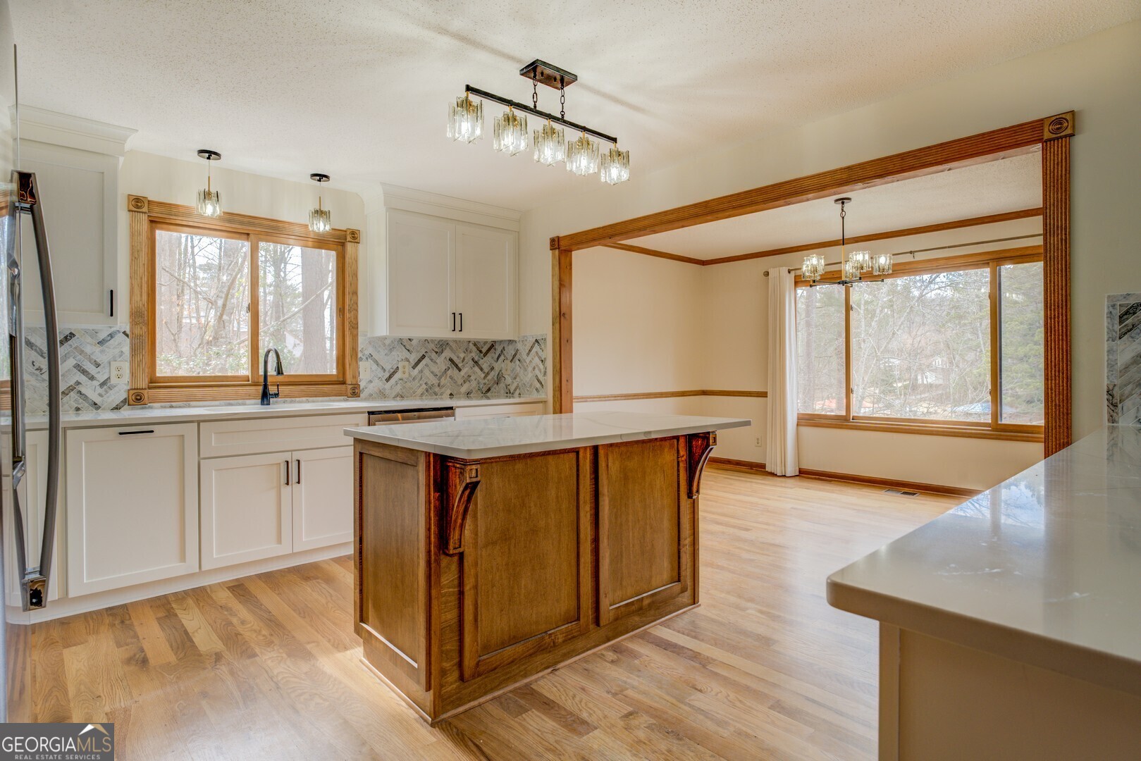 71 Canvasback Court Monticello, GA 31064 - Photo 35 of 78 a kitchen with stainless steel appliances granite countertop a stove a sink and a refrigerator with wooden floor