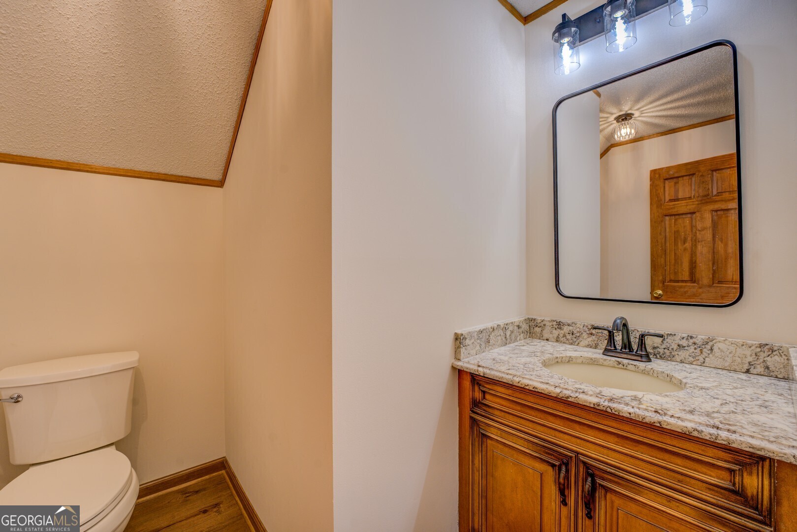 71 Canvasback Court Monticello, GA 31064 - Photo 40 of 78 a bathroom with a granite countertop sink toilet and mirror
