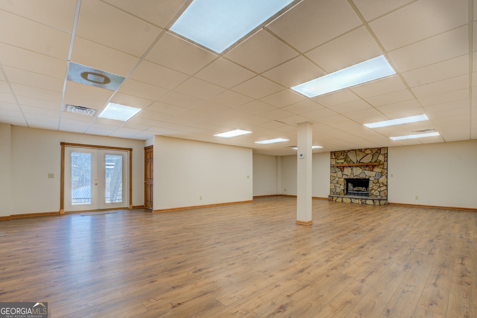 71 Canvasback Court Monticello, GA 31064 - Photo 62 of 78 a view of empty room with wooden floor and fireplace