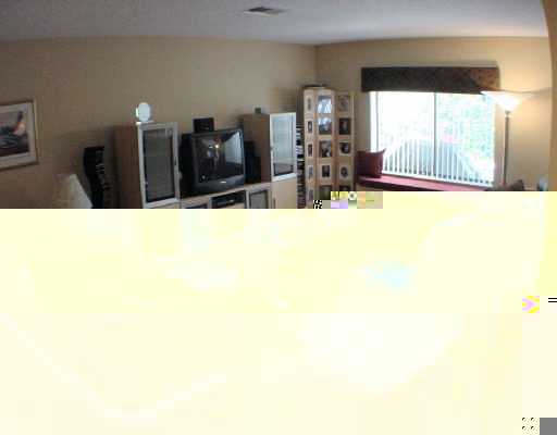320 North Country Club Boulevard, Unit 1 Boca Raton, FL 33487 - Photo 4 of 6 a picture of a living room with a large window