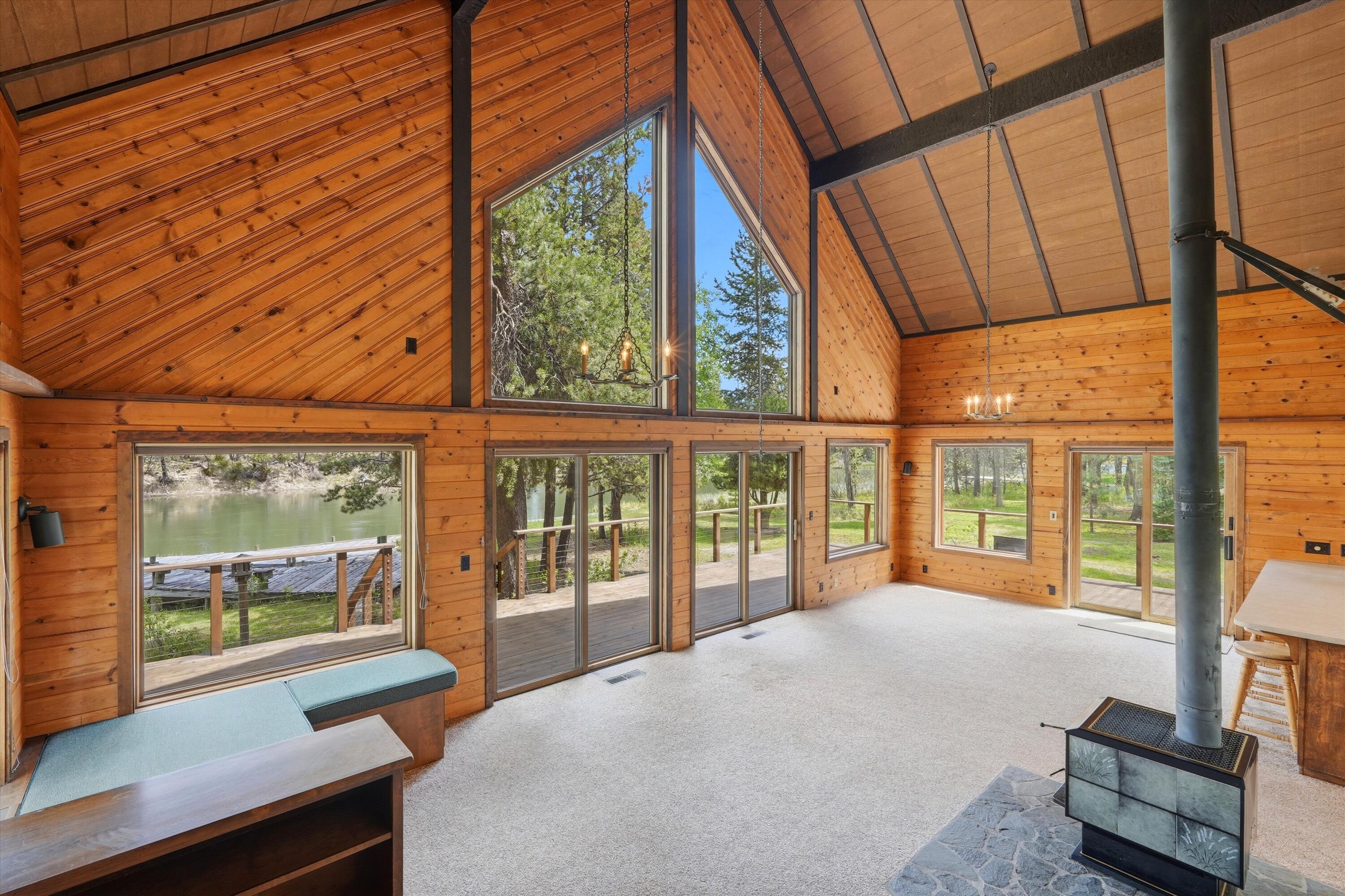 56446 Eclipse Drive Bend, OR 97707 - Photo 27 of 42 a bedroom with furniture and large window