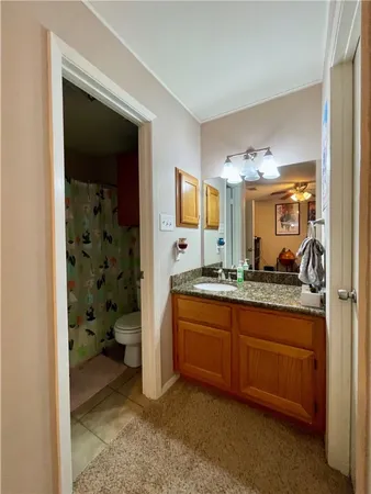 a spacious bathroom with a granite countertop sink and a mirror