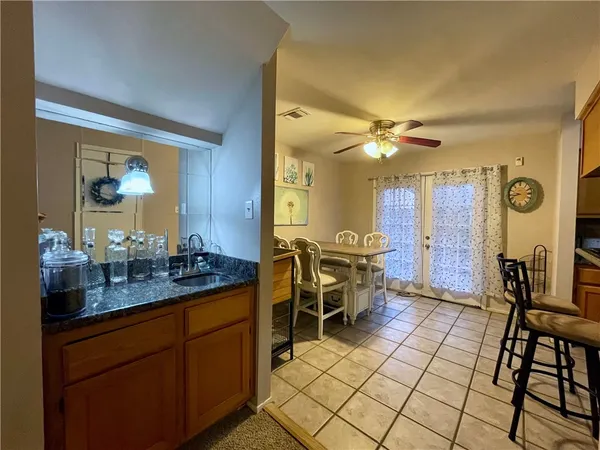 a room with granite countertop furniture a dining table and a painting on the wall