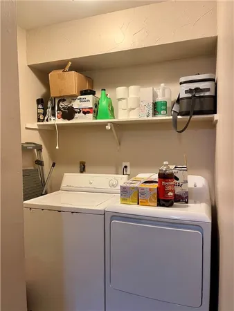 a utility room with sink dryer and washer