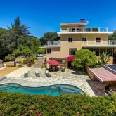 a view of a house with pool and chairs