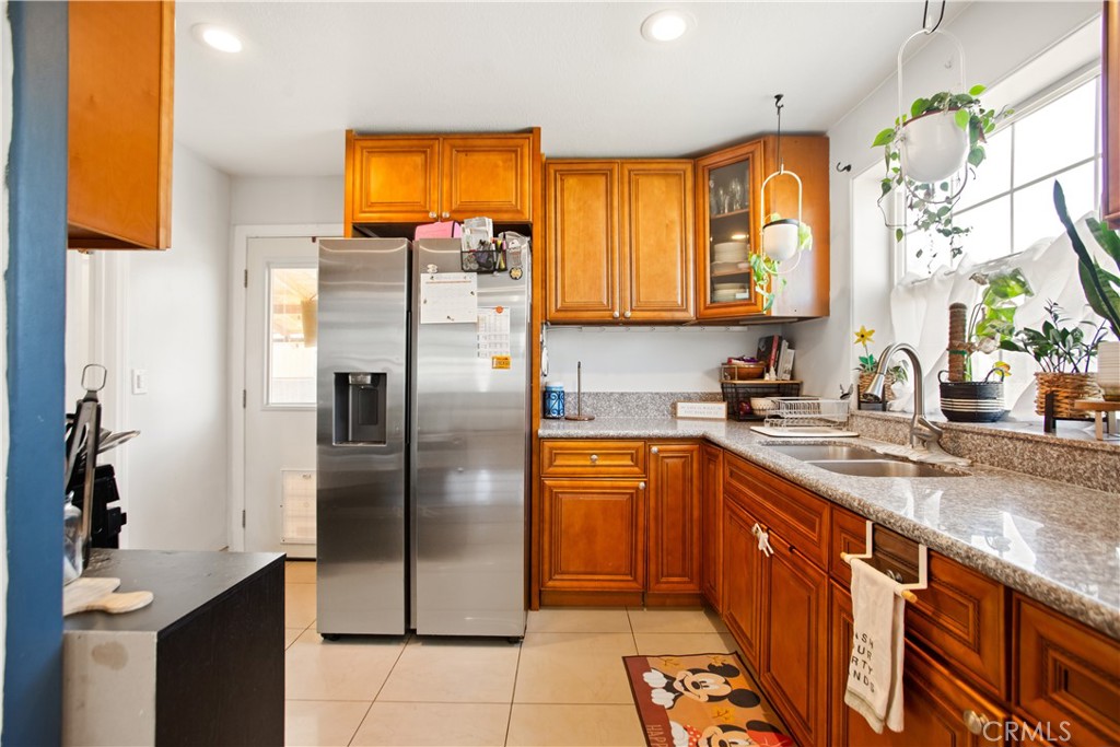 350 North Clifford Avenue Rialto, CA 92376 - Photo 8 of 18 a kitchen with stainless steel appliances granite countertop a refrigerator and a sink