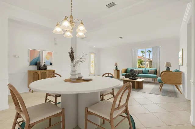 a view of a dining room with furniture and chandelier