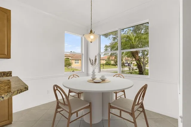a dining room with furniture and window