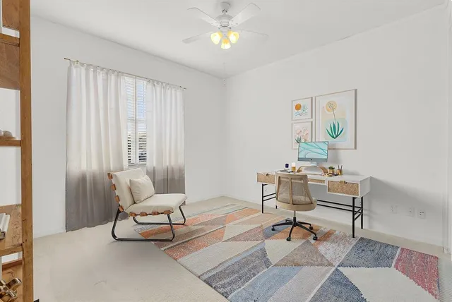 a living room with furniture and a lamp