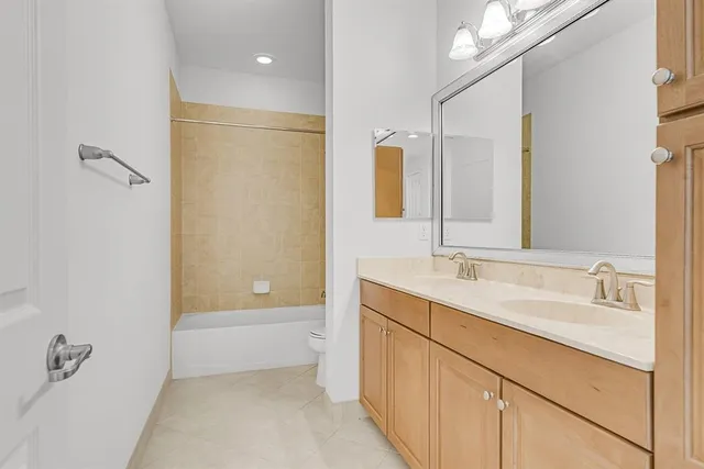 a bathroom with a tub sink and mirror