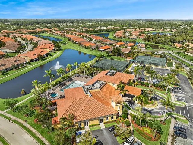 an aerial view of residential houses with outdoor space and river