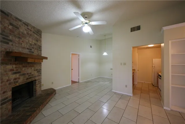 a view of a kitchen with a sink and a fireplace