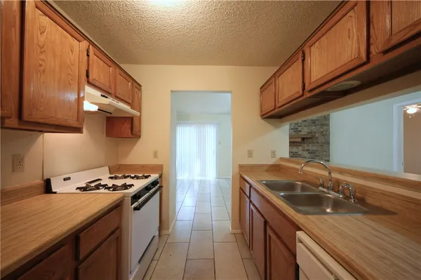 a kitchen with a sink appliances and cabinets