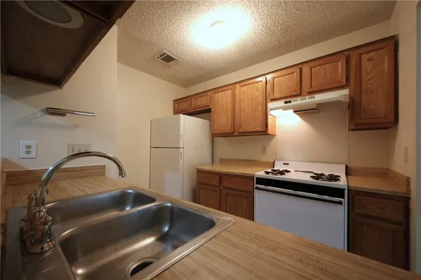 an empty room with a ceiling fan and a window