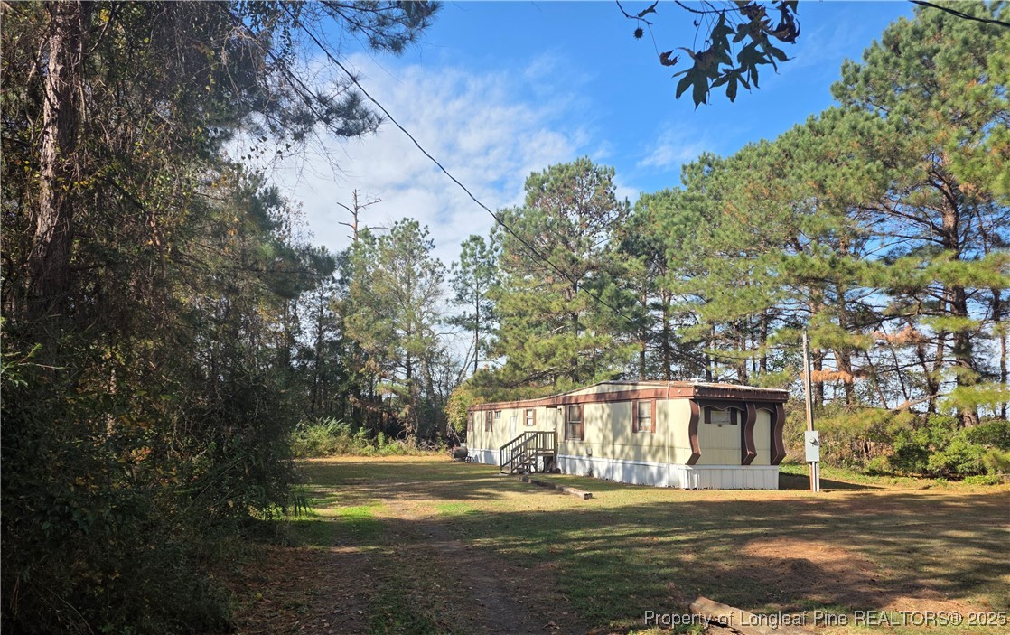 409 Burns Road Lumberton, NC 28358 - Photo 14 of 16 a view of a house with a yard
