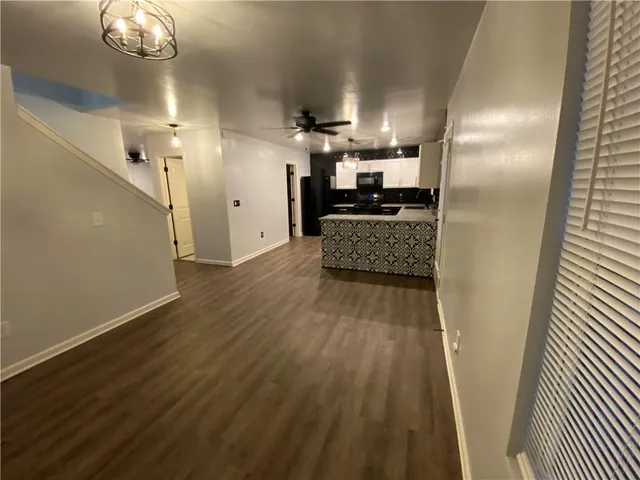 a kitchen with stainless steel appliances granite countertop a sink stove and microwave